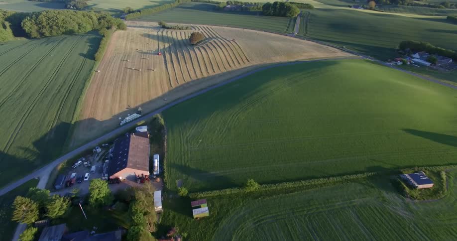 Crops and farmland with buildings nearby