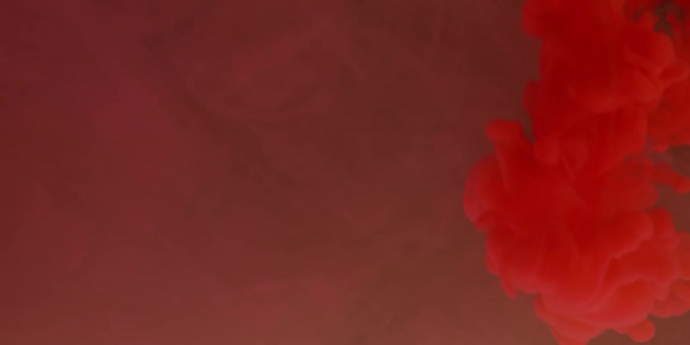Red dye swirls and floats in water