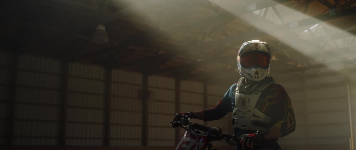 Person sits on a motorcycle as vapor comes out of his helmet