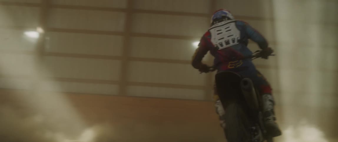 A dirt bike rider spins before driving off