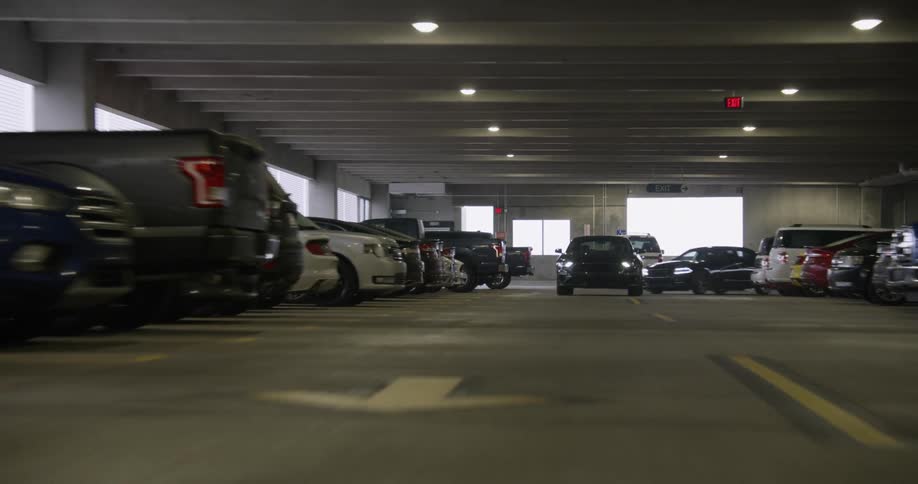 Cars travel through an indoor parking lot