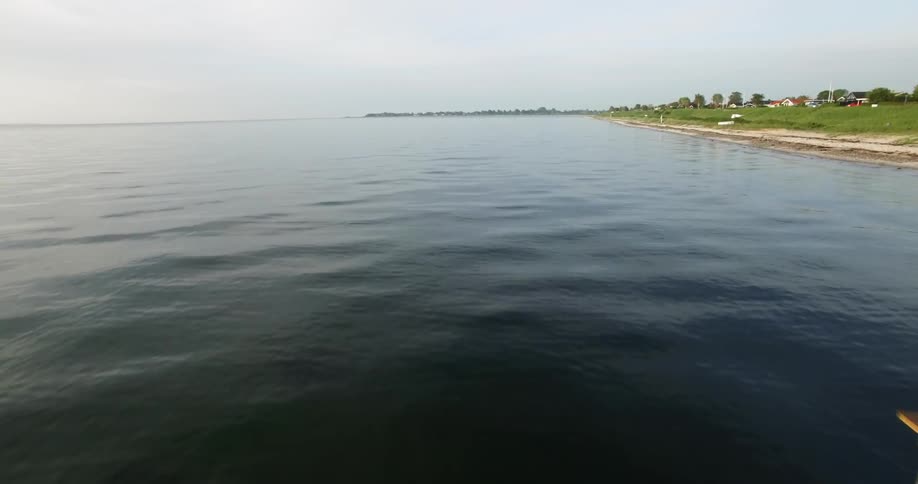 Flying over a lake that is calm