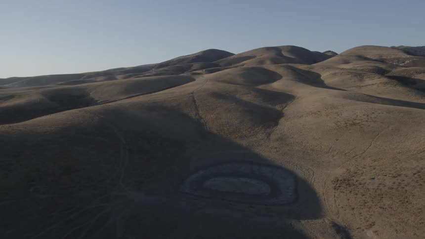 Rolling hills reveal shapes in the fields