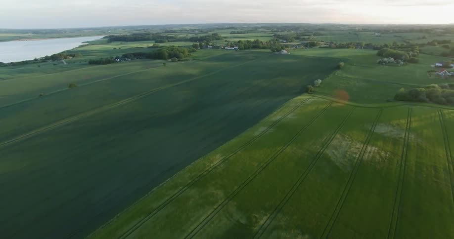 The sun sets over a rural farm