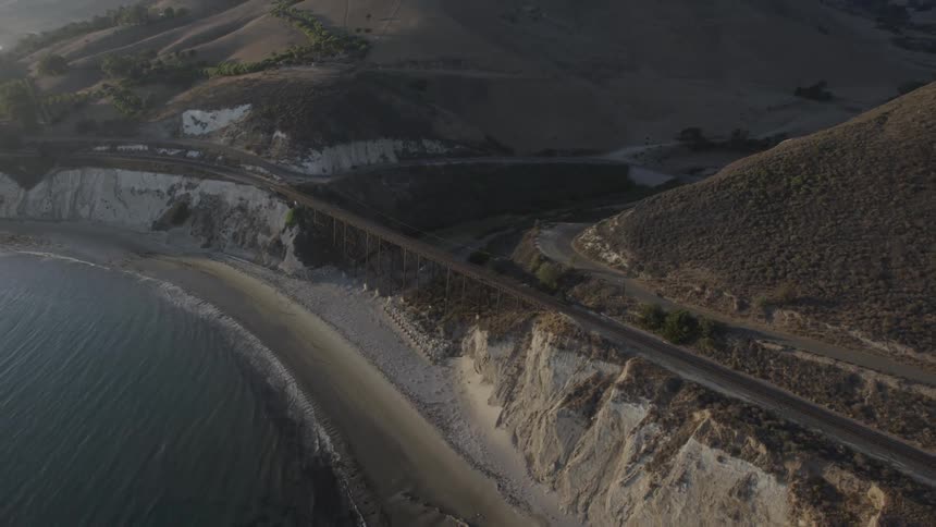 A bridge crosses over a stream near the beach