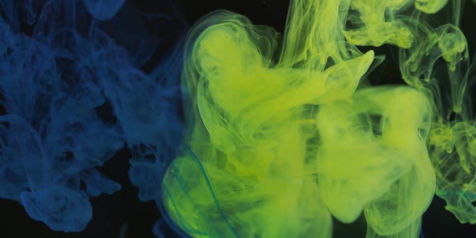 Colorful clouds of smoke drifting next to each other