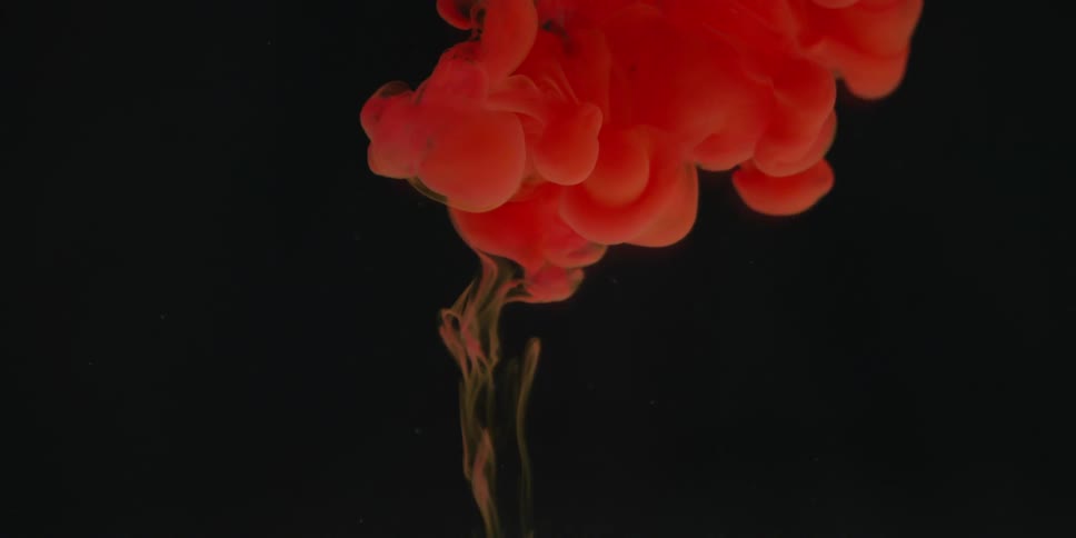 Red liquid billows in clear liquid