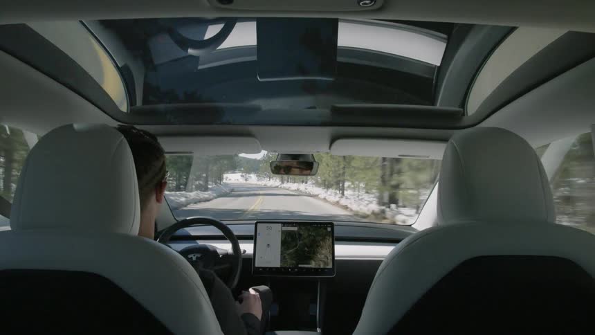 A man drives a car down a road