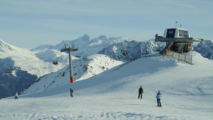 Skiers descend the slope