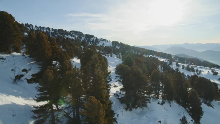 Person skis down the side of a snowy mountain