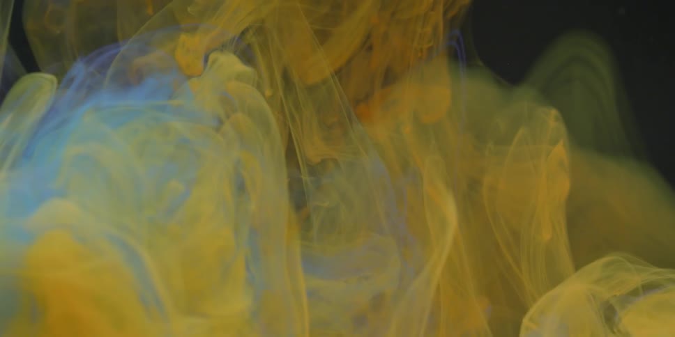 The yellow ink spins in the liquid