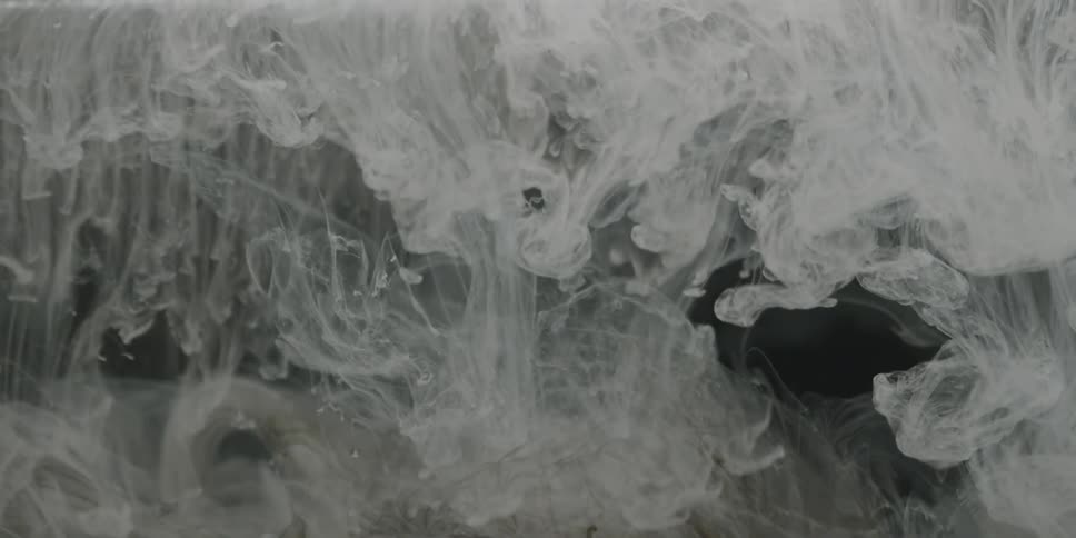 A white liquid swirls and flows