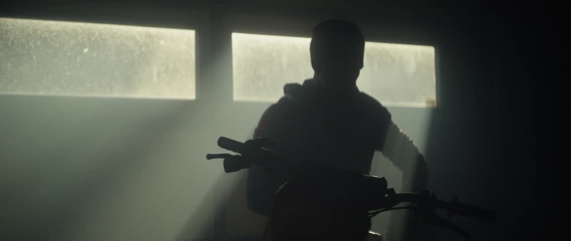 A man puts on a motorcycle helmet