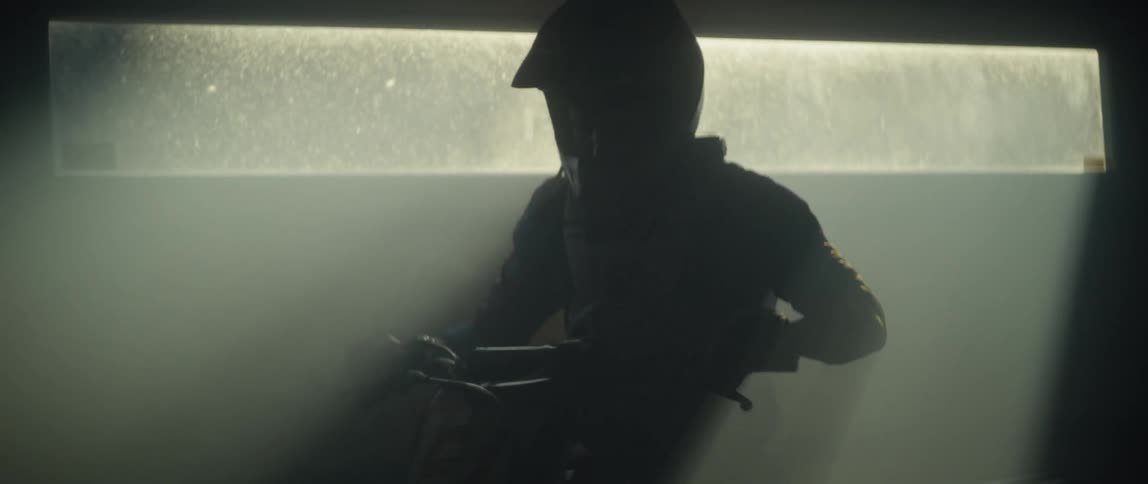 Person rides a dirt bike inside a building