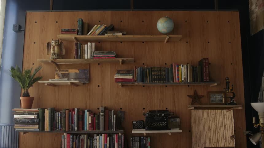 Books and decorations are displayed on wall shelves