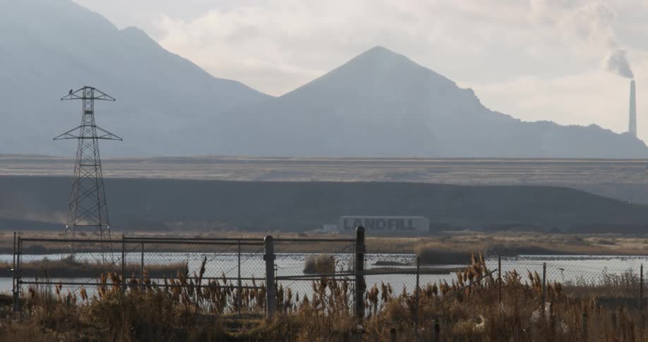 A landfill sits near mountains