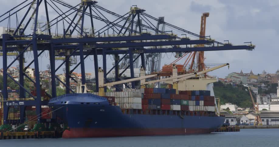 Shipping containers are stacked on a large ship