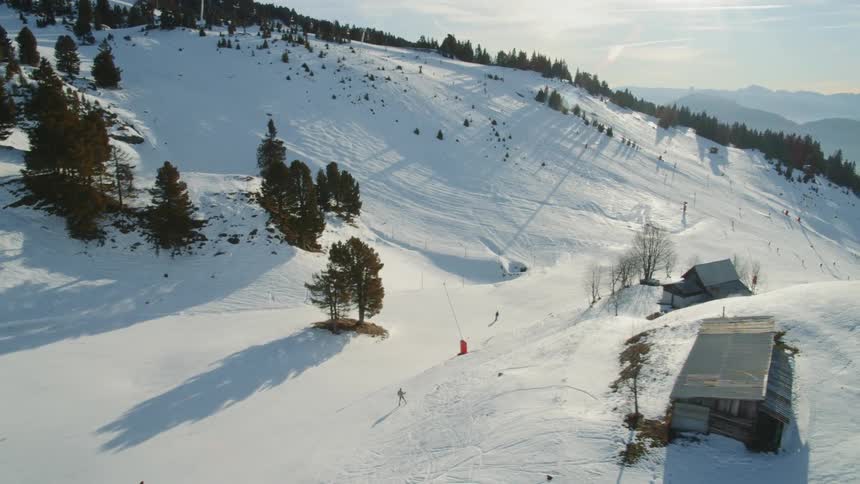 Skiers ski over the snow covered land
