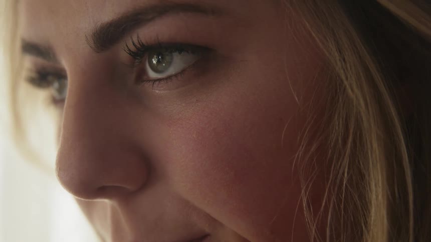 A blond haired woman looks upward