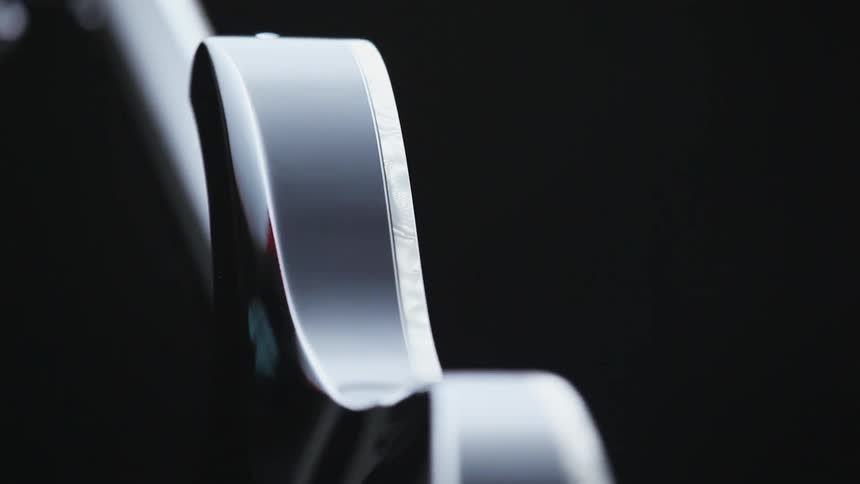 The smooth curves and shape of a guitar against a black background