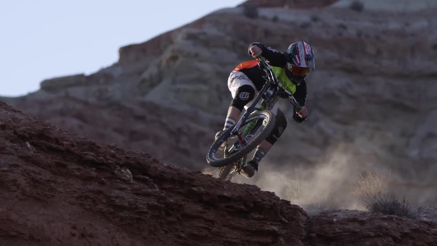A person rides a bike in the desert
