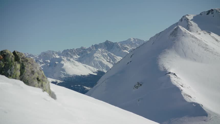 Mountains covered in snow on sunny day