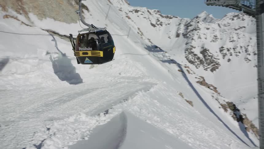 The ski lifts are transporting people over the slopes