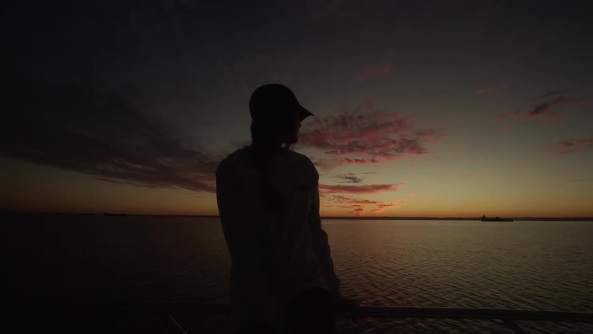 A woman sits on a boat as it travels