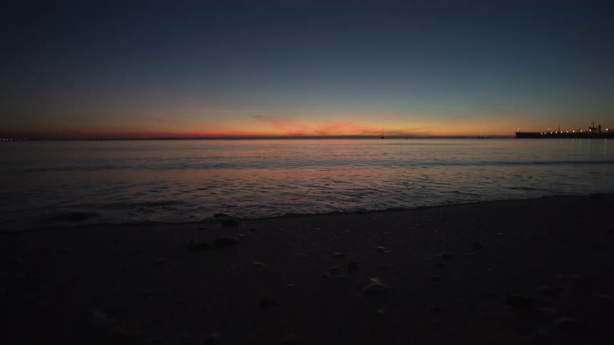 The tide flows gently onto the beach shore