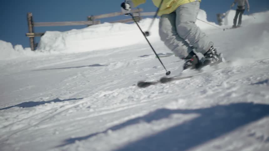 Skiers descend the slope
