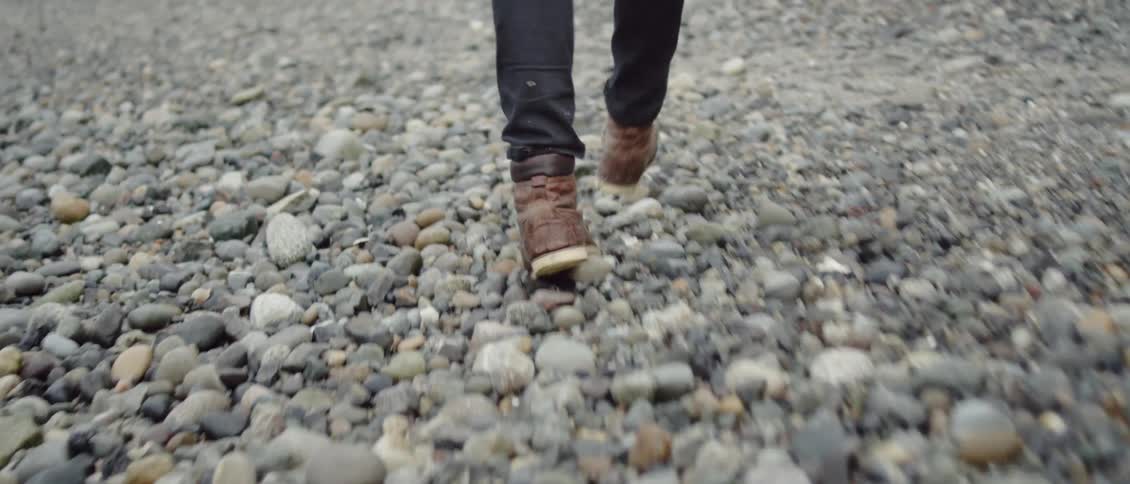 Person walking across rocky land