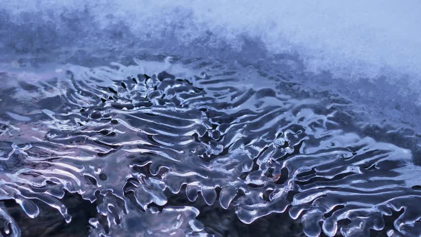 Water flows underneath a crust of ice and snow