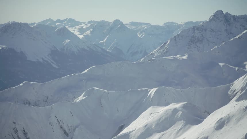 Snow covered mountain range on sunny day