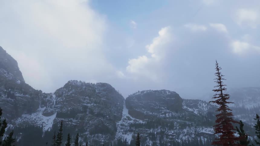 Snow falls on hills and trees