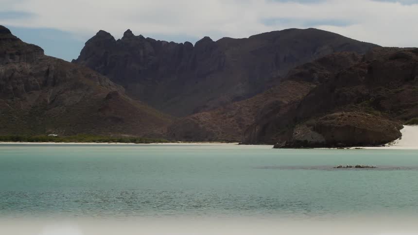 Water flowing with mountains in the background