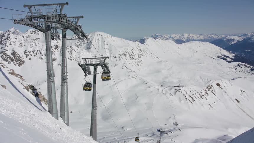 The ski lifts are moving people up and down the slopes
