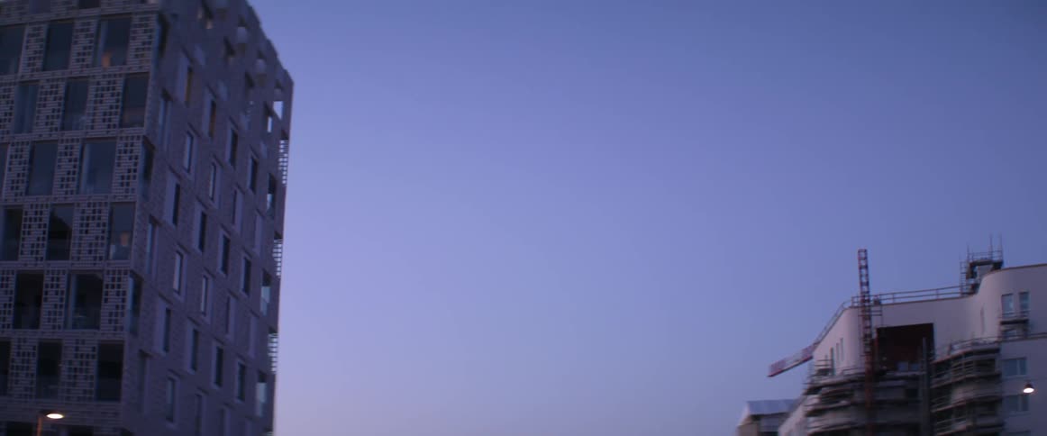 A beautiful gradient sky shines over contemporary downtown architecture during a calm sunset.