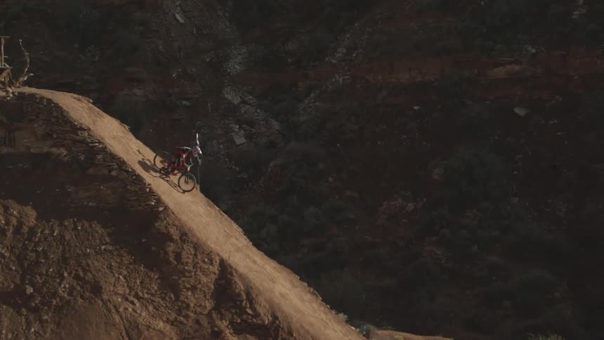 Man jumps his bike down a very steep hill