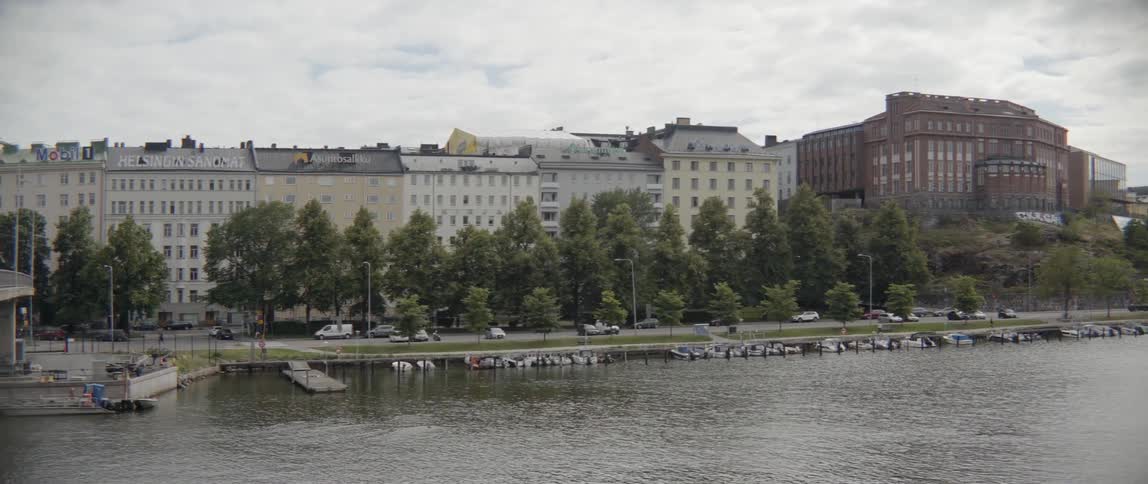 The tide is rippling in a river in an old world city on a cloudy day