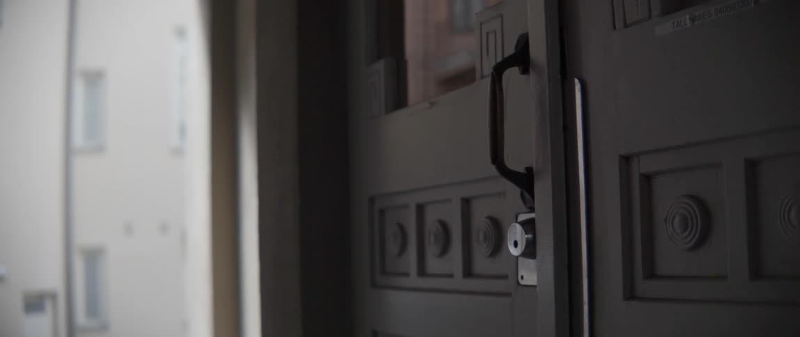 An old residential door handle and lock system on a classic city house.