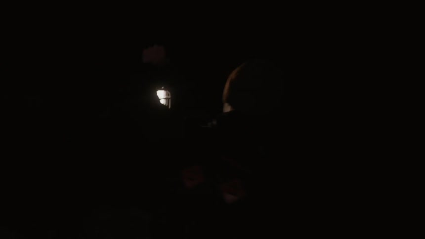 A man explores a cave holding a lantern