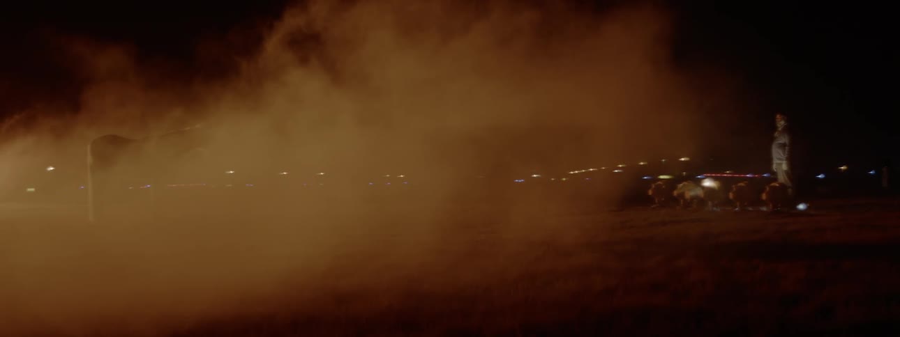 Lights are visible through a cloud of smoke