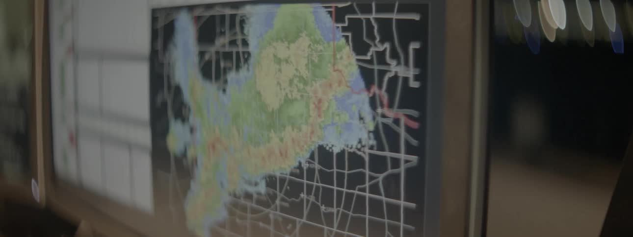 A monitor shows radar images of a storm moving