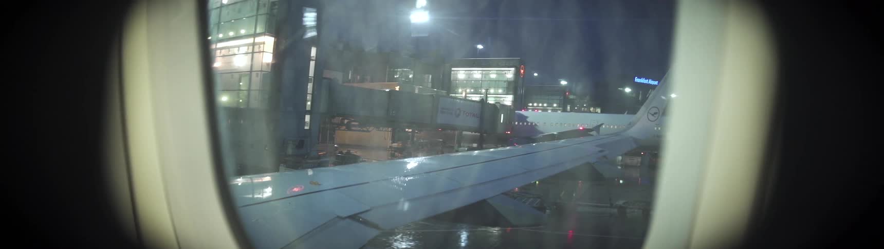 Rain falls on an airplane window