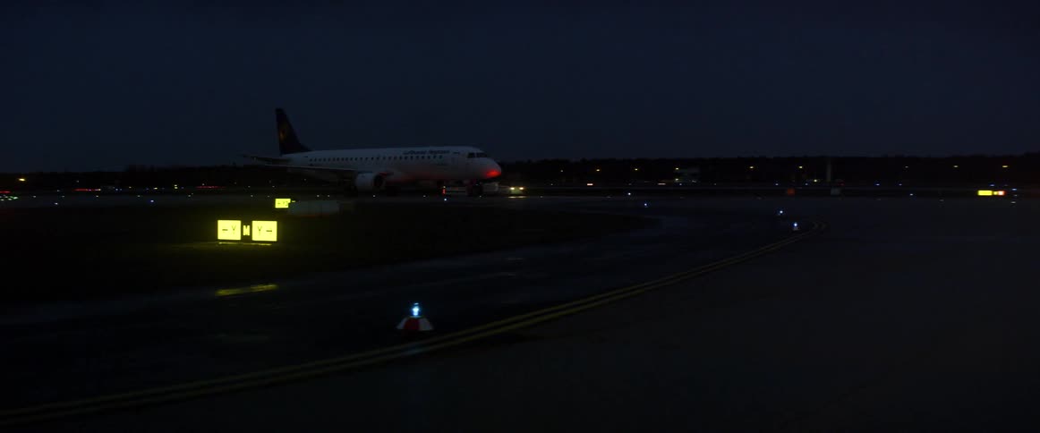 Airplane lands on an airstrip at night