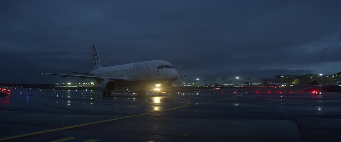 Airplane lands on an airstrip at night