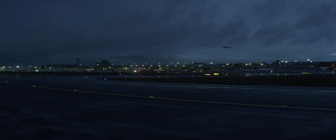 Airplane landing in a city at night