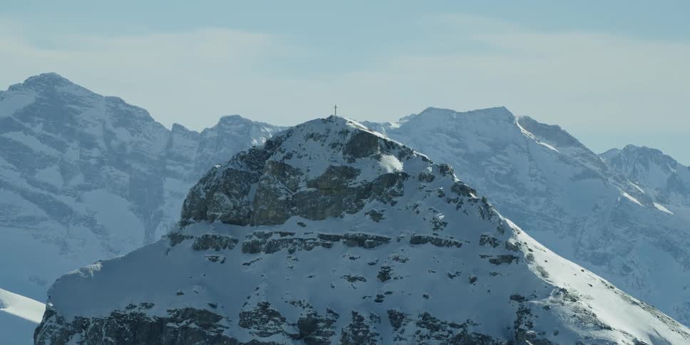 Snow covers a rocky mountain peak