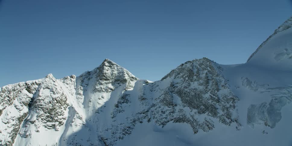 Sun shines down on snowy mountains