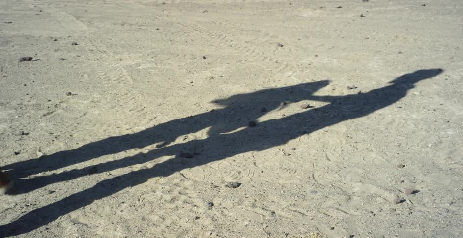 A man and woman dance in a desert